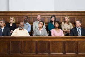  A jury listening to case presentations in a courtroom.