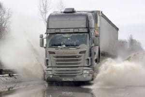 Black semi-trailer truck about to get into a trucking accident 