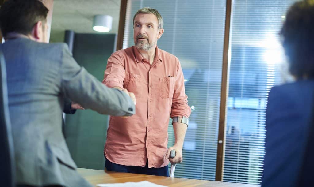  An injured man meeting with his car accident attorney. 