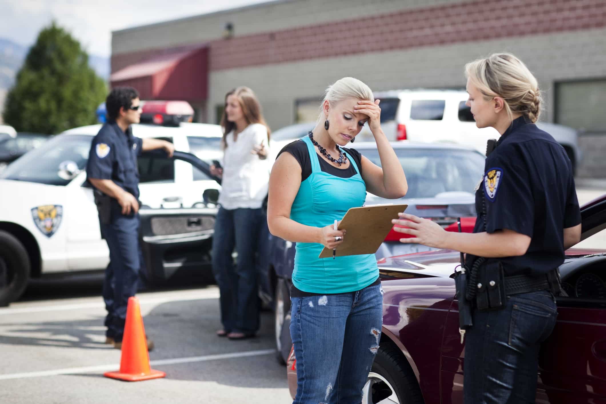 A woman talking to a police officer after getting into a car accident