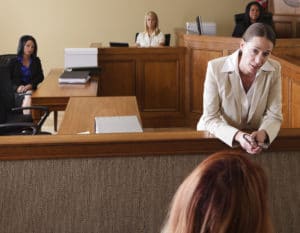 A woman lawyer addressing the jury in the courtroom.