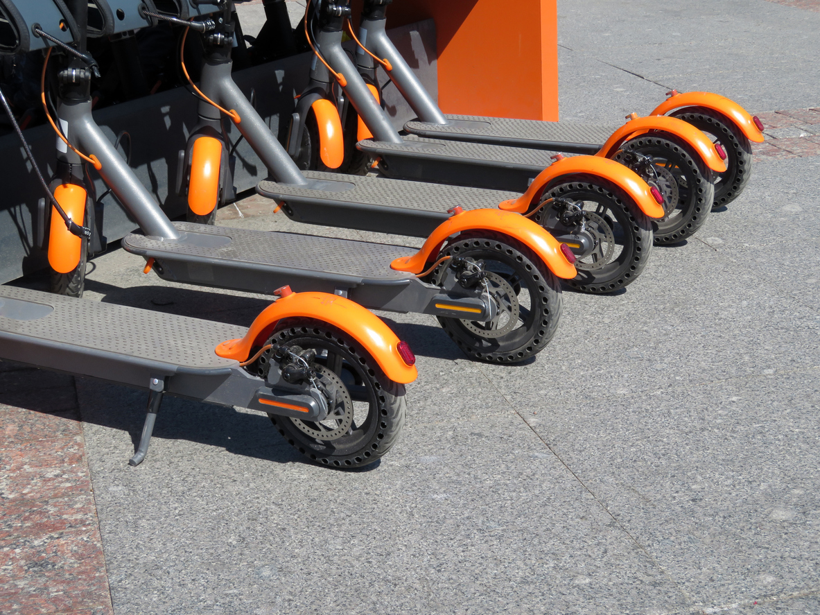 Motor scooters in row on the parking lot