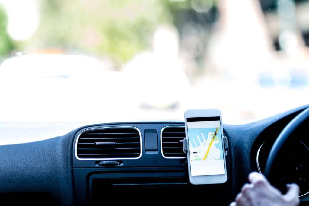 Taxi driver using GPS to follow the route.