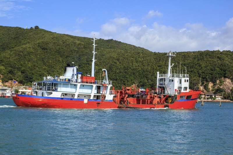 Two red vessels on water near shoreline, illustrating potential boating accident scenario