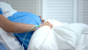 woman giving birth in hospital bed
