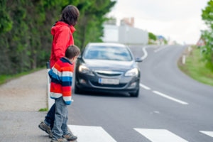 a parent and child attempting to use a cross walk