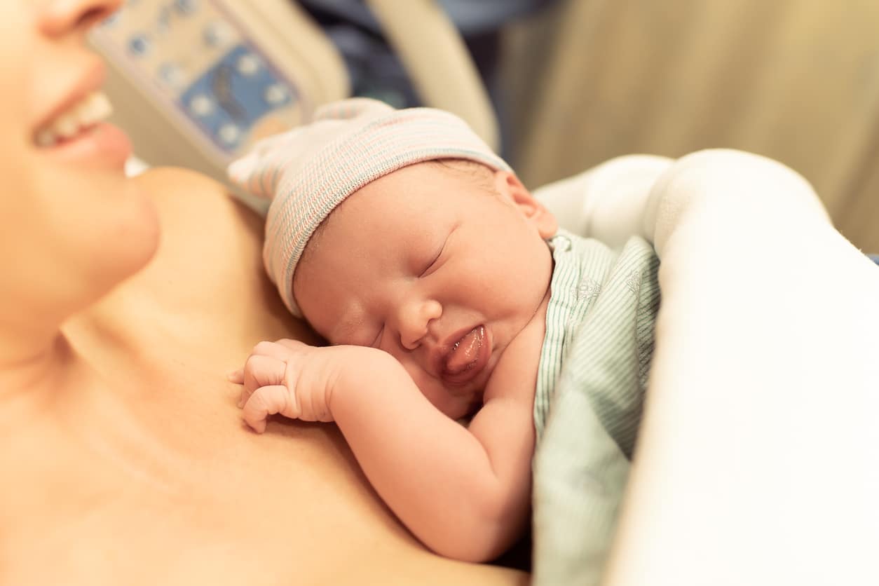 a baby with Caput Succedaneum laying on mom's chest