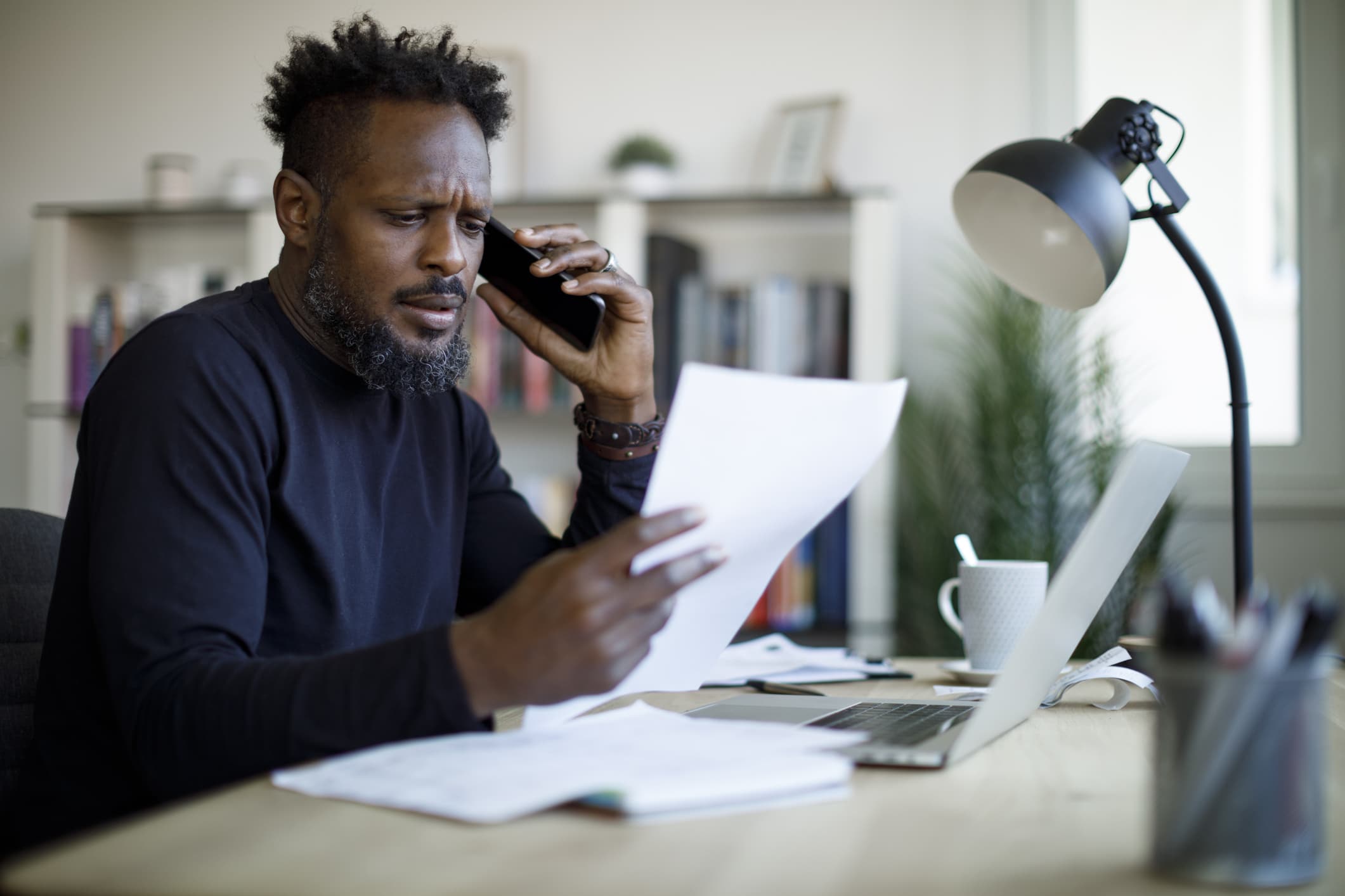 A man in Austin, Texas is on the phone with an insurance company discussing his car accident claim.