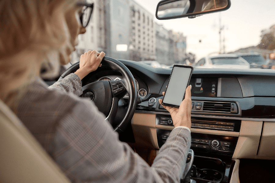 businesswoman texting and driving