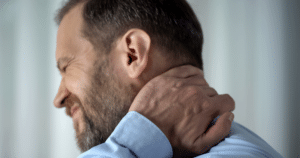man grimacing from neck pain