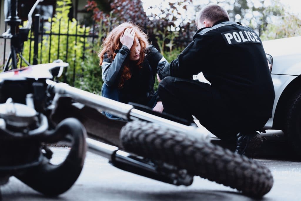 A woman talking to the police after a motorcycle accident in Austin, TX.