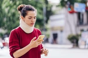 An injured woman contacting her Waco, TX, personal injury lawyer.