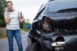 A woman on the phone with her insurance company after a car accident.