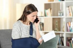 An injured woman calling an Austin truck accident attorney about a free case review.