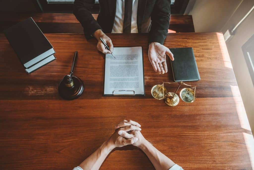 A lawyer helping a client go over paperwork in Austin, Texas.