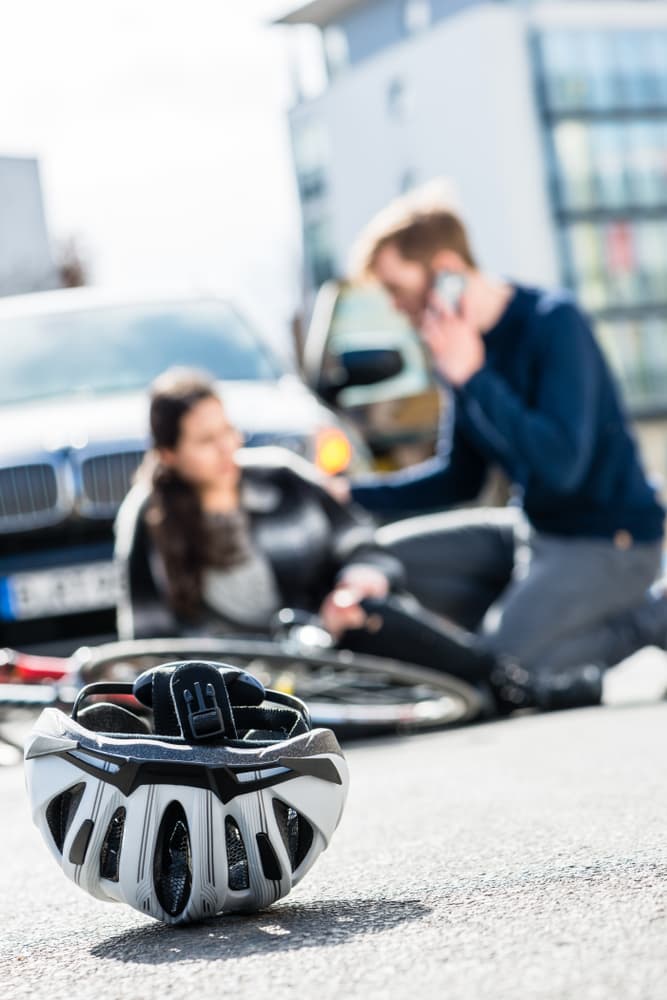 Bicycle helmet on the ground after a collision with a car. Close-up view of a safety gear fallen during an unfortunate biking incident.