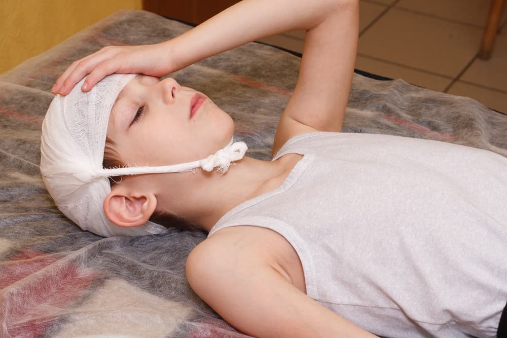 Traumatic brain injury first aid medical bandage of a young boy in the hospital