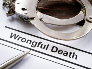 Handcuffs and pen on a document labeled 'Wrongful Death', indicating legal consequences of negligence.