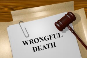 Paperwork labeled "Wrongful Death" with a gavel atop a wooden desk, symbolizing legal proceedings in wrongful death claims