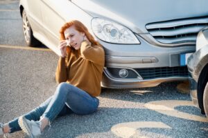 Woman in pain after a car accident, emphasizing the physical and emotional toll of injuries sustained in a collision.