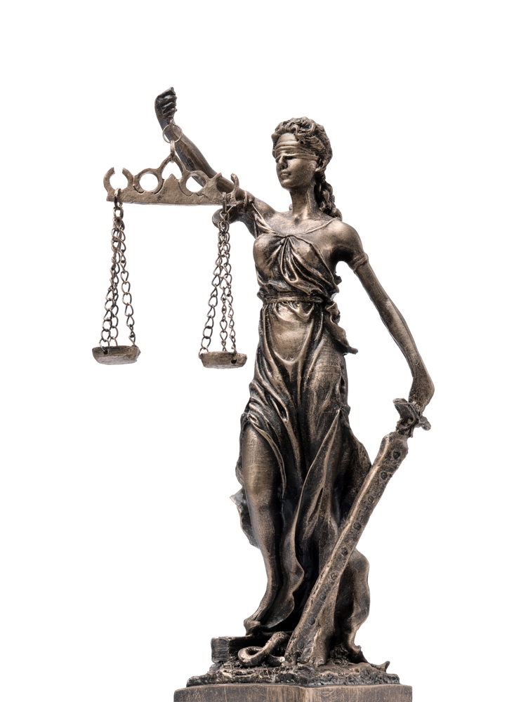Isolated Lady Justice statue on white background, representing fair treatment under the law – a powerful symbol of justice.