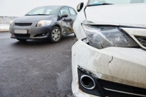 "Car crash involving Uber and Lyft vehicles on a street.