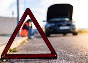 A female motorist with a head injury exiting her car after a crash in Waco, Texas, captured from the rear view.