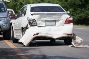 Car crash scene on a busy main road during travel.