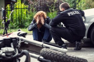 Frightened victim of a motorcycle-car collision with a policeman.