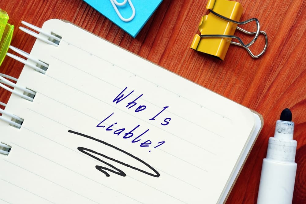 Legal concept meaning Who Is Liable? with inscription on the page.
