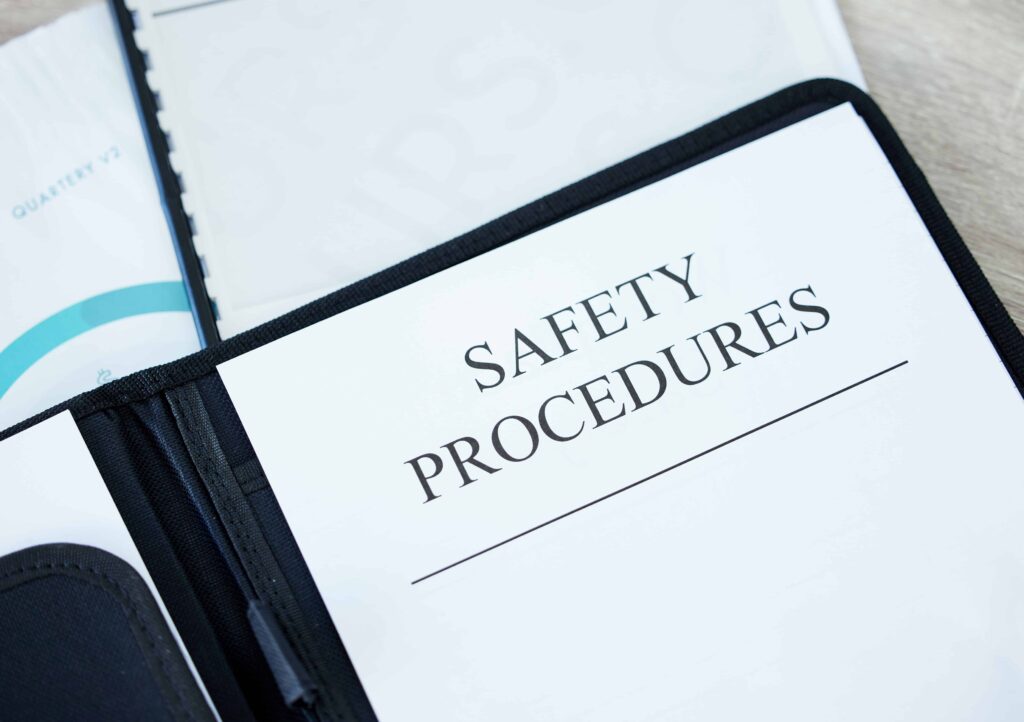 Safety procedures document inside a binder, highlighting workplace health and safety guidelines and compliance policies.