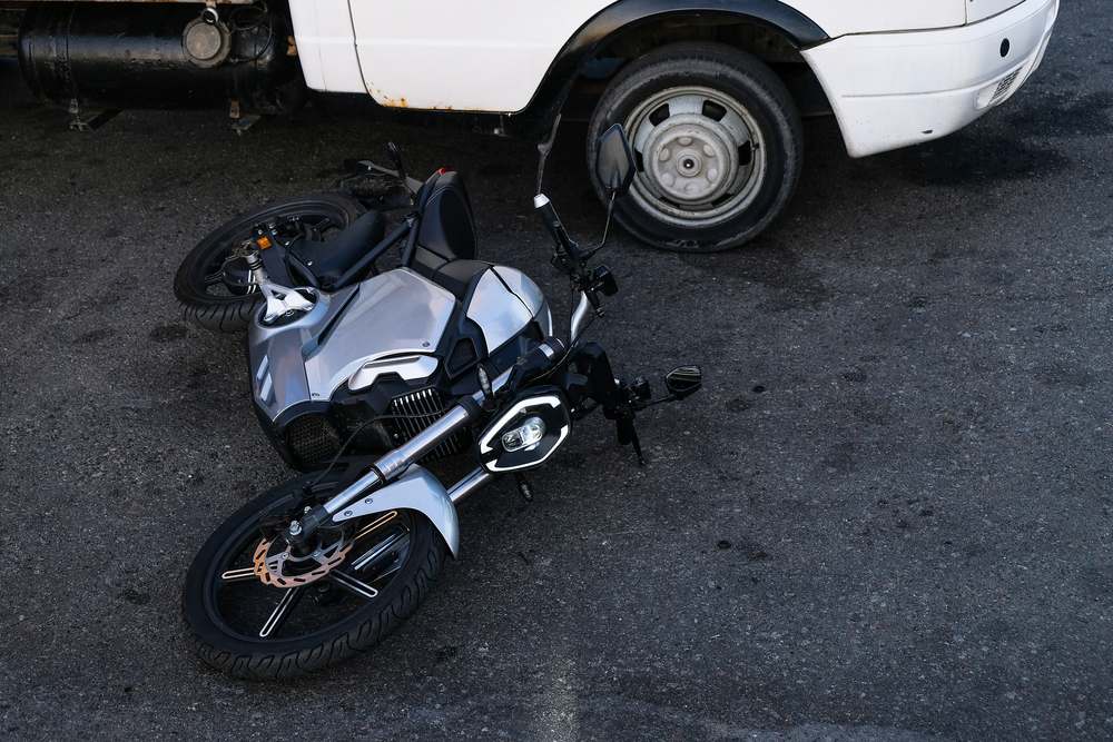Motorcycle on the ground next to a vehicle after a collision, illustrating a Killeen motorcycle accident claim