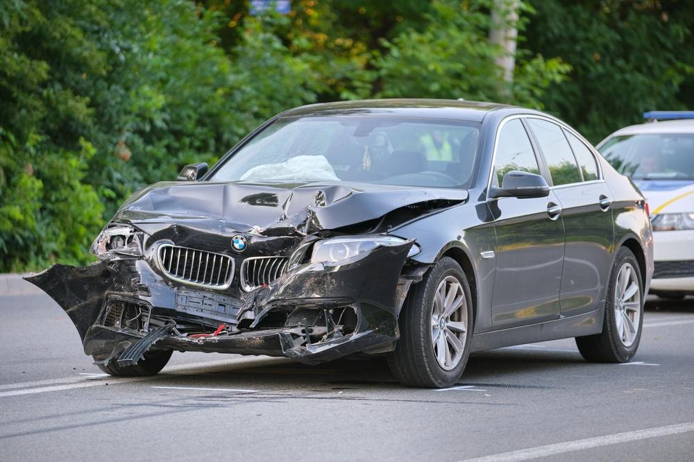 Heavily damaged vehicle with police on scene after a car accident near Fort Cavazos