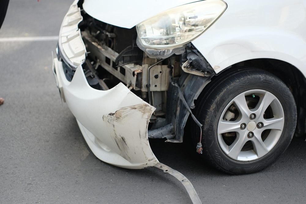 Close-up of a damaged front bumper and headlight after a car accident in Killeen
