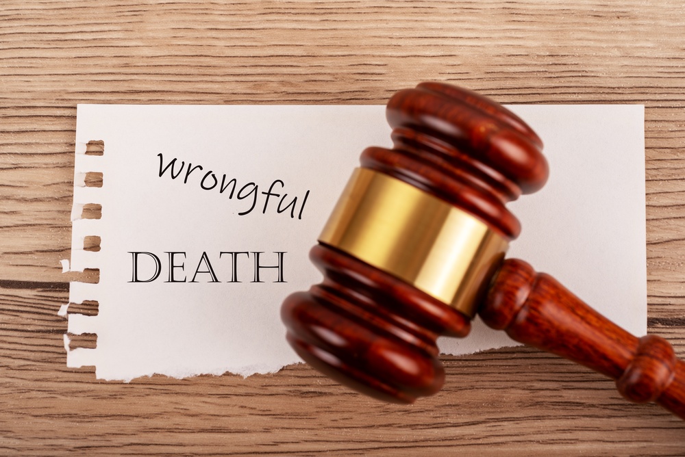 Judge gavel over wrongful death text, legal lawsuit, justice and compensation concept.